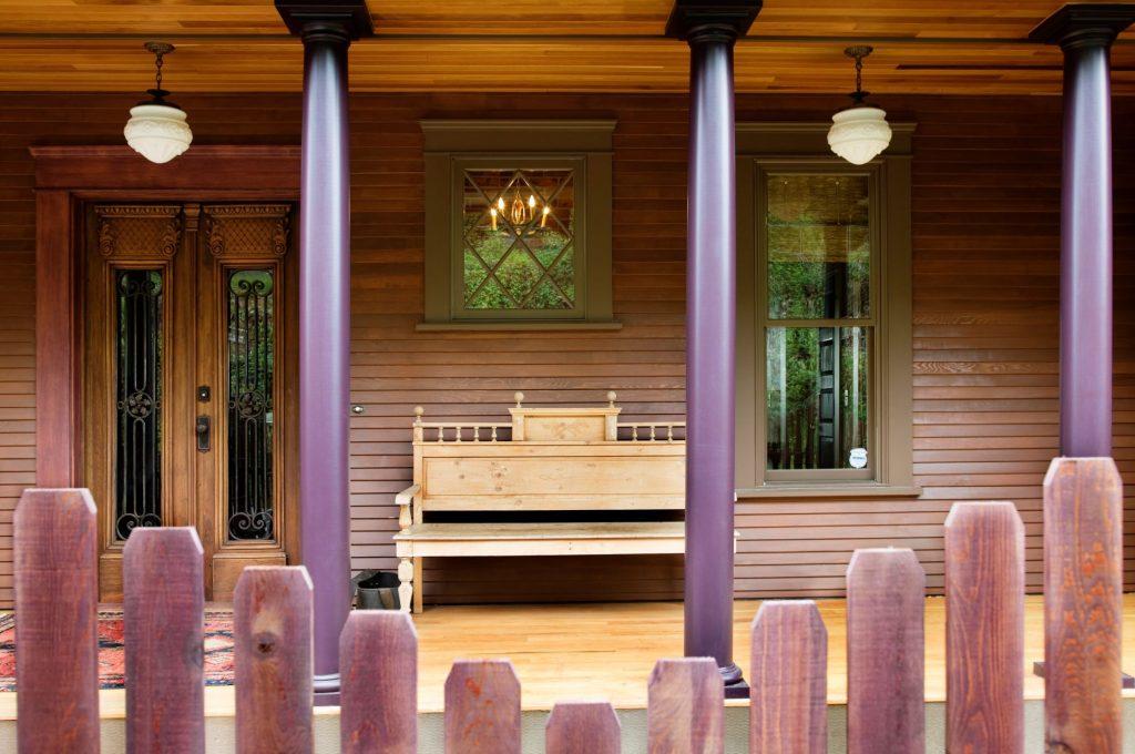 wooden fence and house porch with columns and benc 2023 11 27 05 16 02 utc